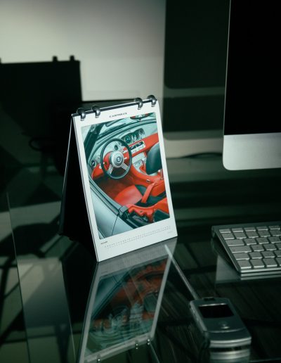 Carphiles 2025 Classic Car Calendar featuring a white Porsche 911 Targa against an architectural backdrop"