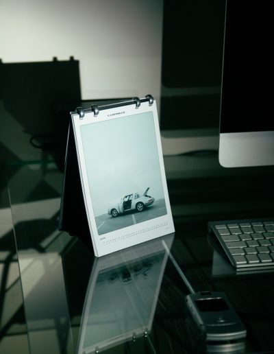 Carphiles 2025 Classic Car Calendar featuring a white Porsche 911 Targa against an architectural backdrop"